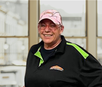 smiling brunette woman with Servpro hat and shirt on