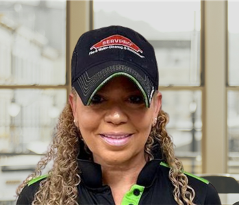 Woman with long hair and a servpro hat on