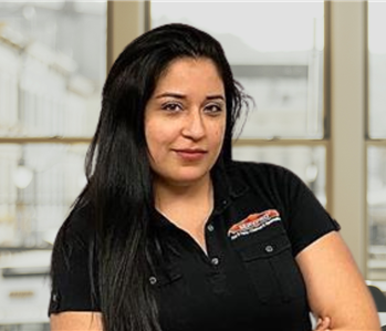 woman with long brown hair and servpro shirt on