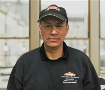 Middle aged man with a servpro hat and shirt