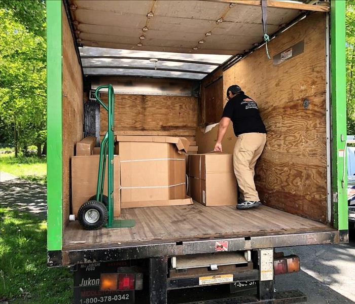 man loading boxes into a servpro truck