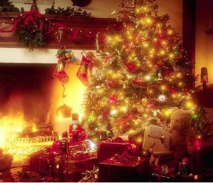 christmas tree with presents next to a fireplace